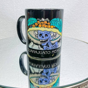 An artistic mug featuring a Dia de los Muerto, Guanajuata Mexico